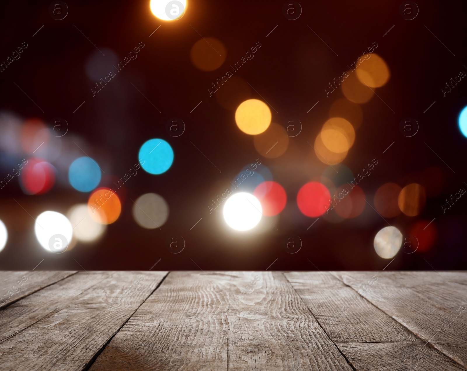 Image of Empty wooden surface against blurred lights. Bokeh effect 