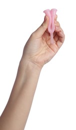 Photo of Woman folding pink menstrual cup on white background, closeup
