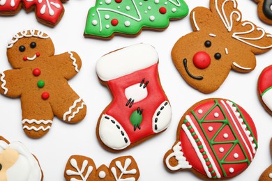 Photo of Different tasty Christmas cookies on white background, flat lay