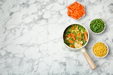 Photo of Flat lay composition with frozen vegetables on marble background