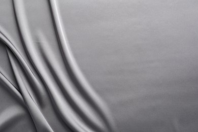 Photo of Texture of beautiful light grey silk fabric as background, closeup