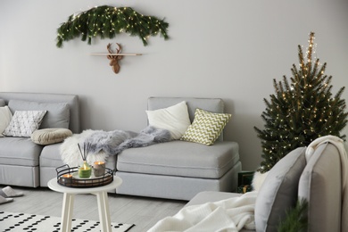 Photo of Stylish living room with Christmas decorations. Interior design