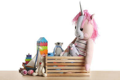 Photo of Set of different toys on wooden table against white background