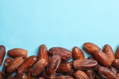 Photo of Sweet dried date fruits on color background, top view. Space for text