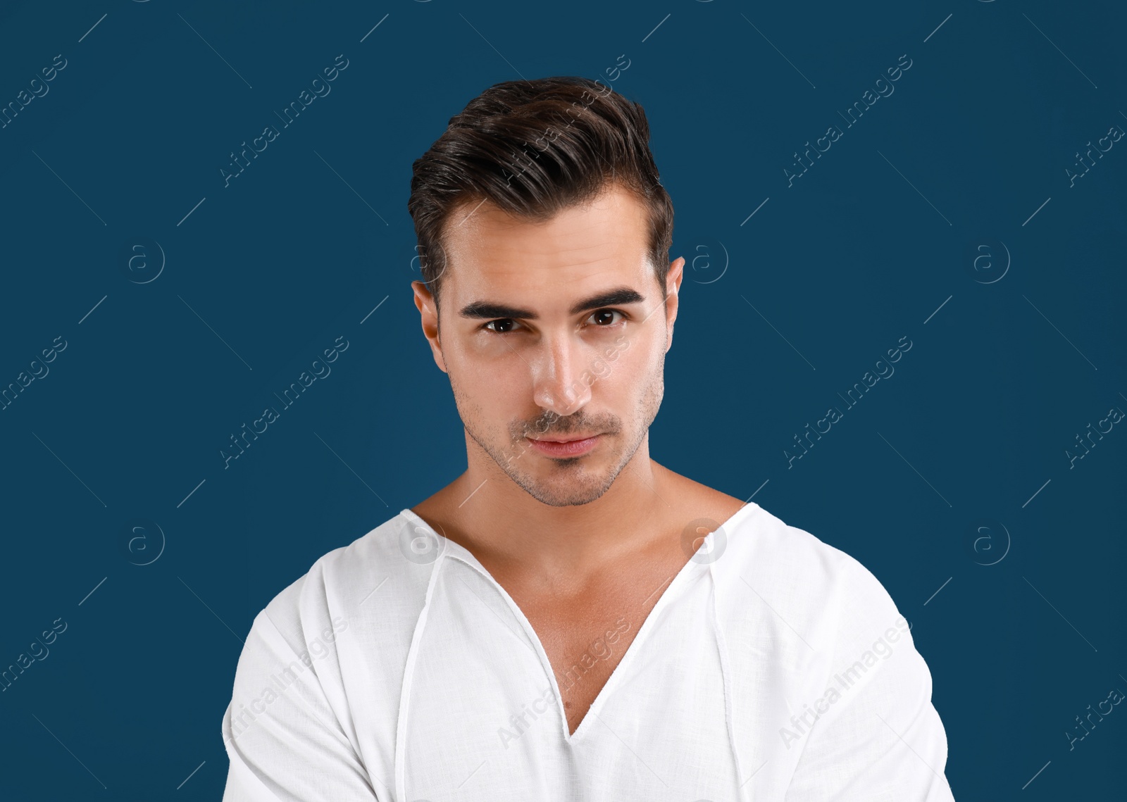 Photo of Portrait of handsome young man on blue background