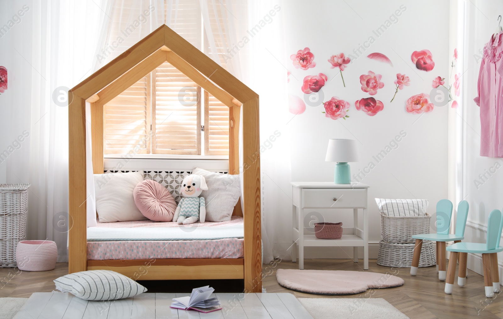 Photo of Stylish child room interior with wooden house bed