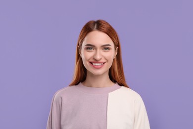 Photo of Beautiful woman with clean teeth smiling on violet background