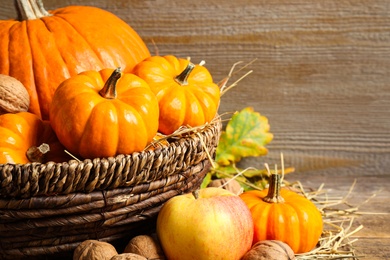 Composition with ripe pumpkins on wooden table, closeup. Happy Thanksgiving day