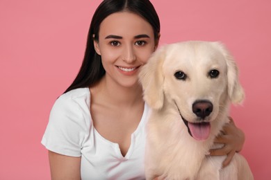 Photo of Happy woman with cute Labrador Retriever dog on pink background. Adorable pet