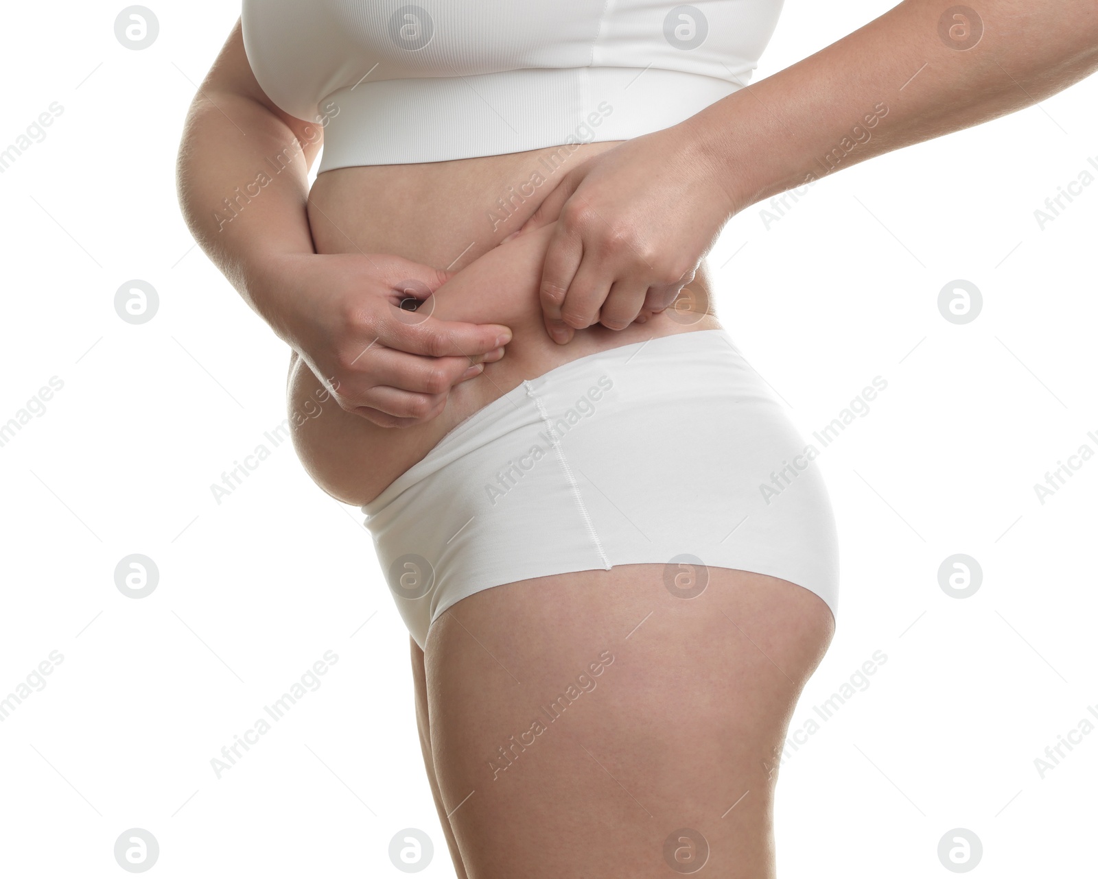 Photo of Woman touching belly fat on white background, closeup. Overweight problem