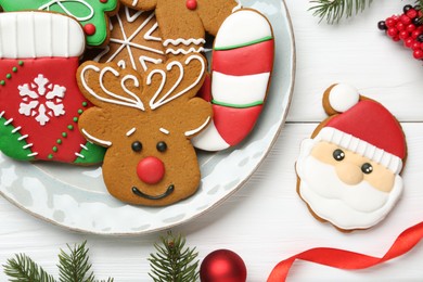 Tasty homemade Christmas cookies and decor on white wooden table, flat lay