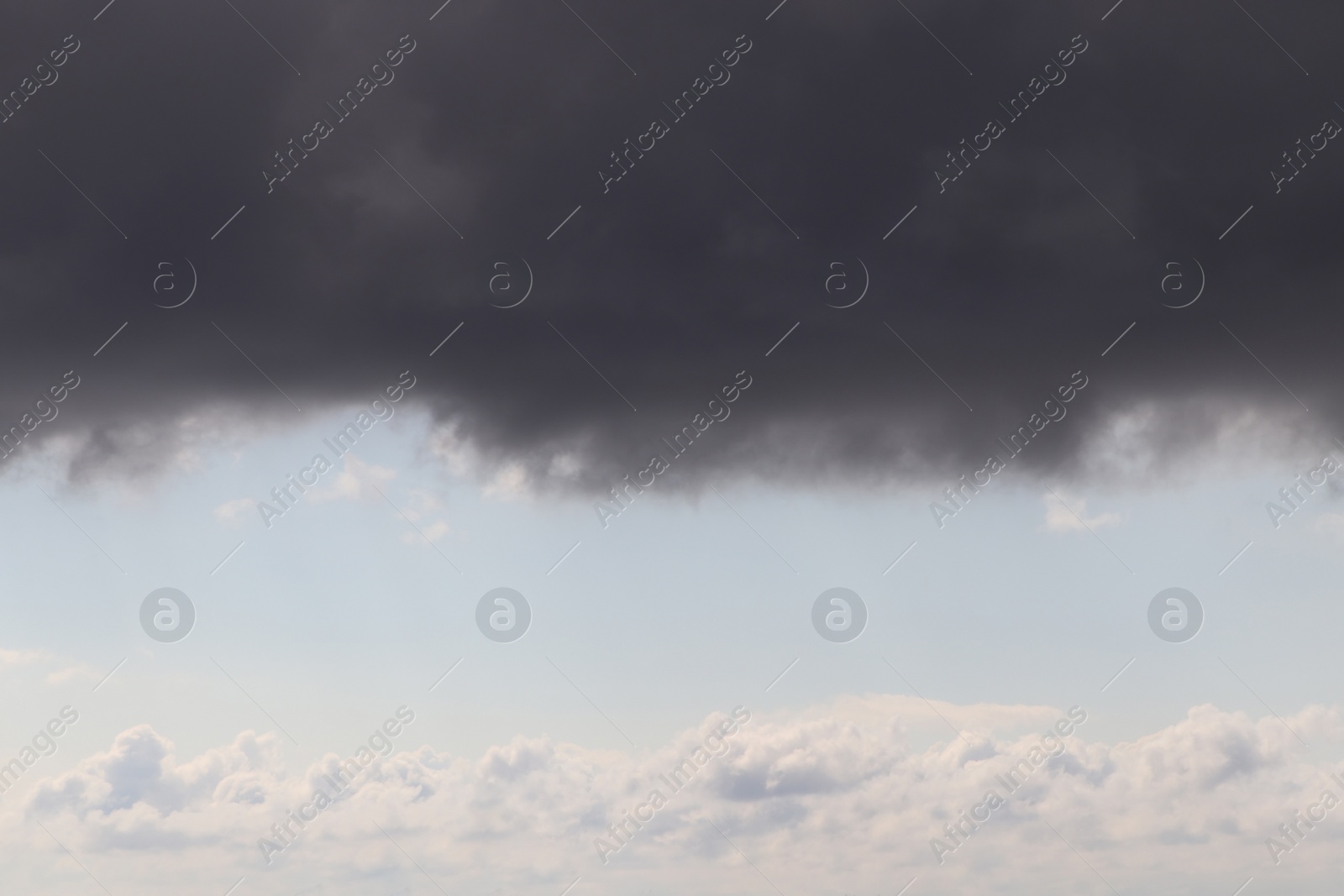 Photo of Sky with heavy rainy clouds on grey day