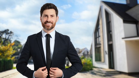 Image of Handsome real estate agent near beautiful house outdoors. Space for text