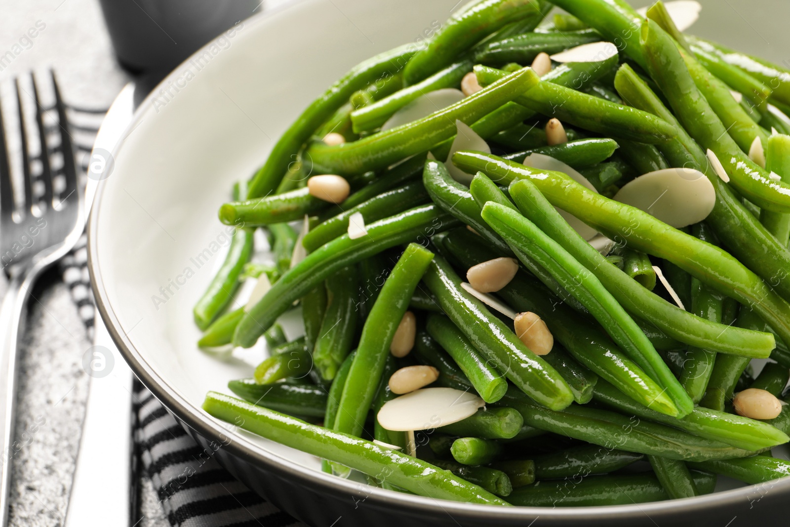 Photo of Tasty salad with green beans served on table, closeup