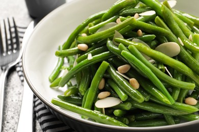 Photo of Tasty salad with green beans served on table, closeup