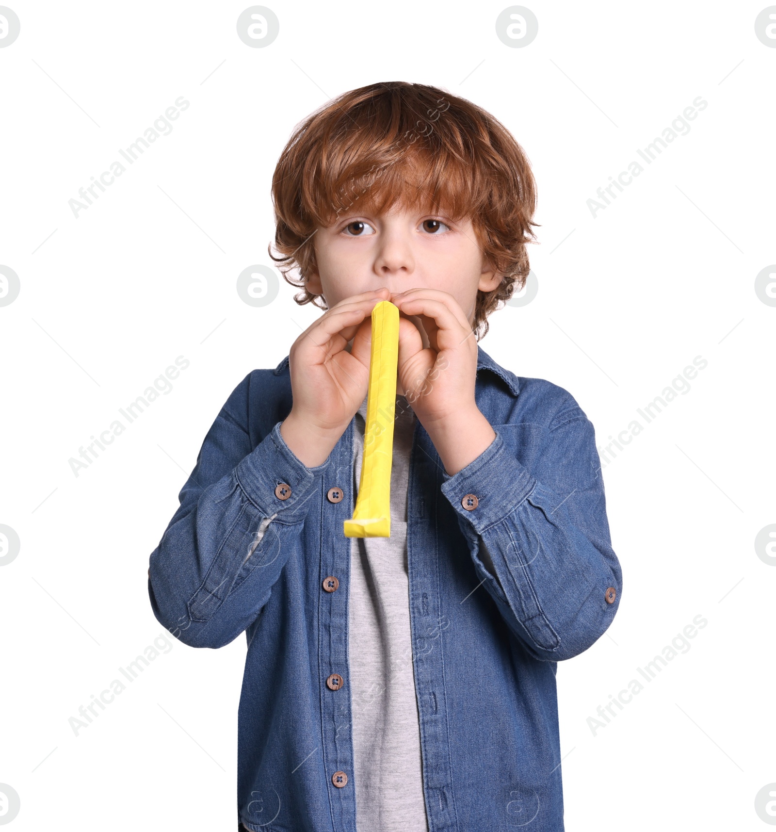 Photo of Birthday celebration. Cute little boy with blower on white background