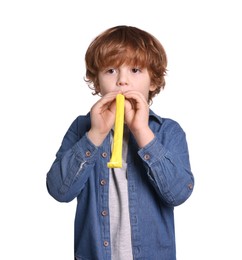 Photo of Birthday celebration. Cute little boy with blower on white background