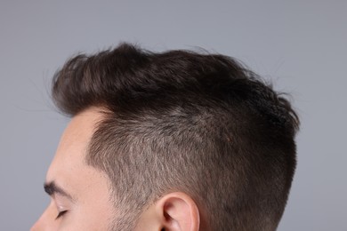 Photo of Man with healthy hair on light grey background, closeup