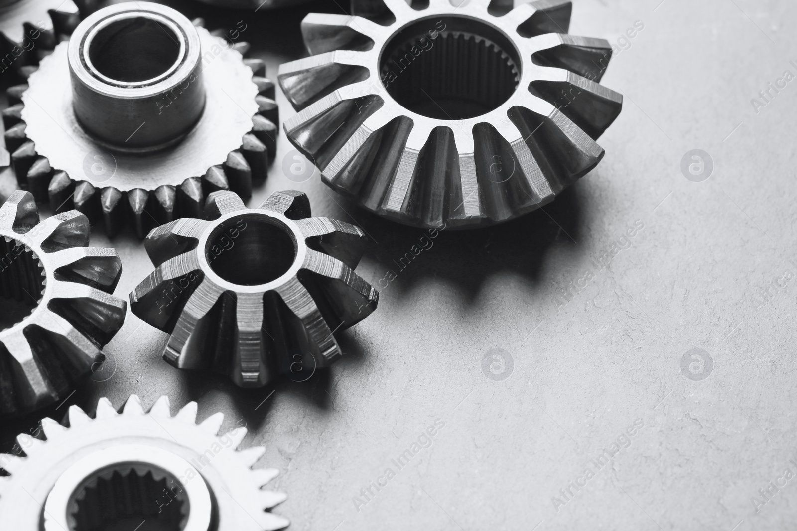 Photo of Different stainless steel gears on light grey background, closeup