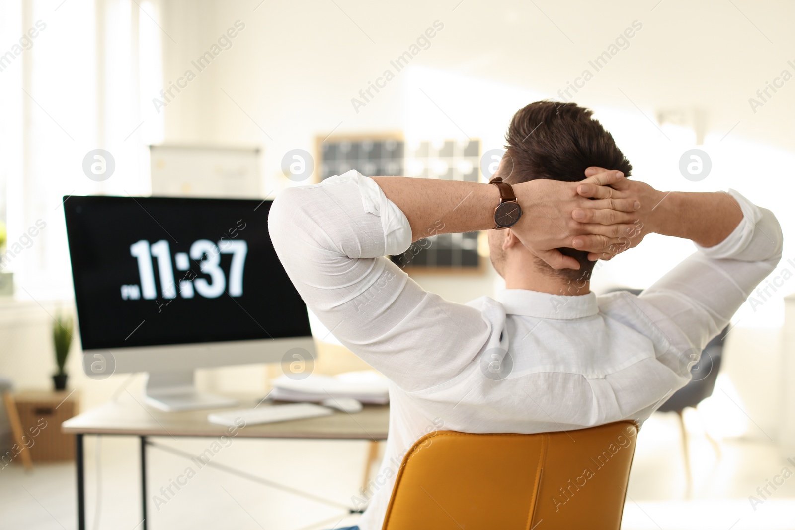 Photo of Young businessman relaxing at table in office during break