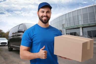 Image of Happy courier with parcel showing thumbs up outdoors