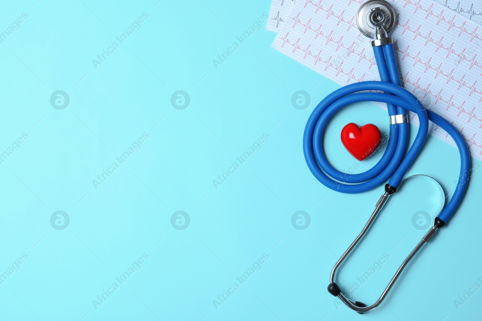 Photo of Stethoscope with red heart and cardiogram on blue background, flat lay. Space for text