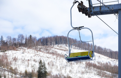 Photo of Empty chairlift at mountain ski resort. Winter vacation