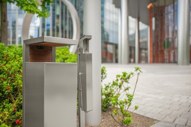 Photo of Recycling bin for waste near building outdoors