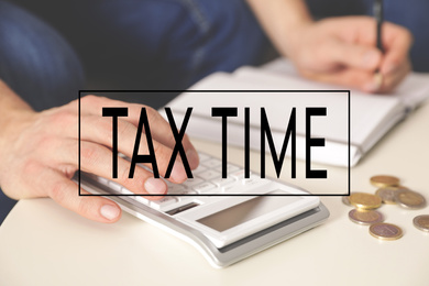 Image of Tax accountant working with calculator and money at table, closeup