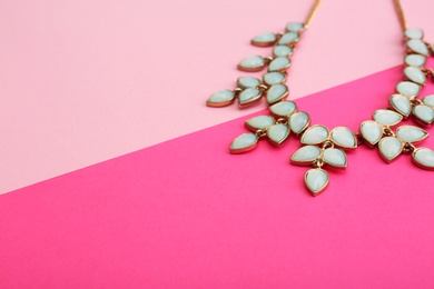 Beautiful necklace on color background, closeup. Space for text