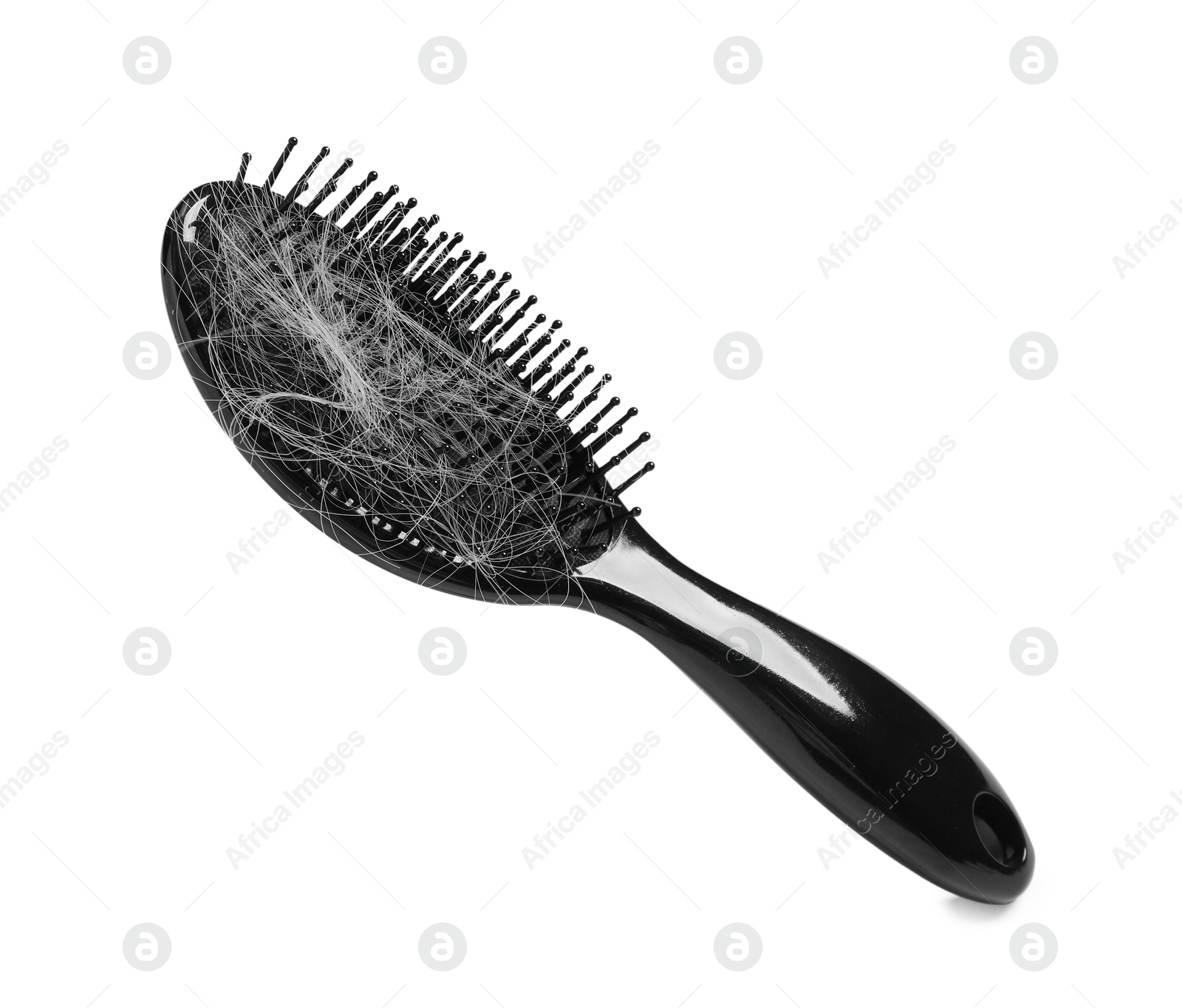 Photo of Brush with lost hair in air on white background