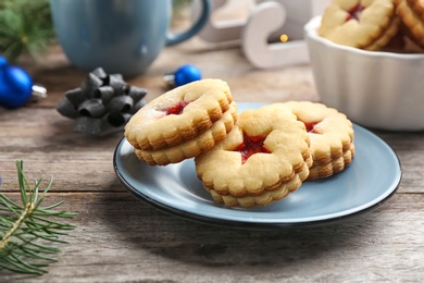 Photo of Traditional Christmas Linzer cookies with sweet jam on plate