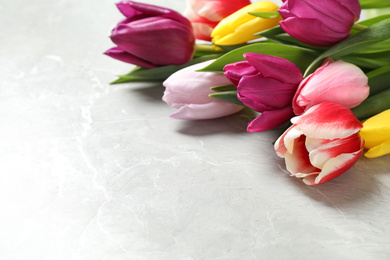 Beautiful spring tulips on marble table, closeup. Space for text