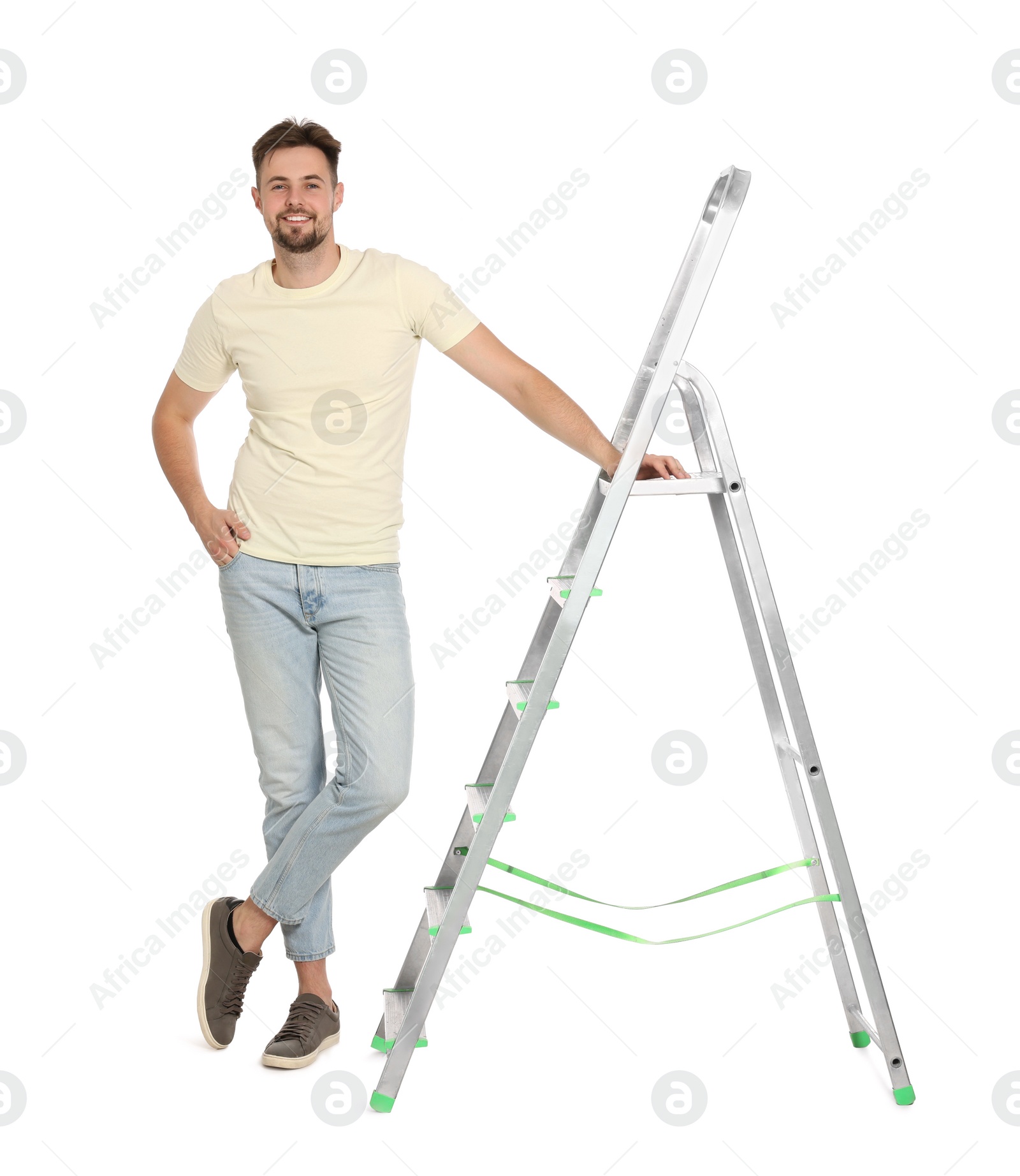 Photo of Young handsome man near metal ladder on white background