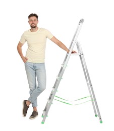 Photo of Young handsome man near metal ladder on white background