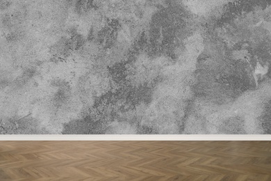 Wooden floor and empty grey wall indoors