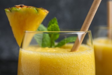 Tasty pineapple smoothie in glass, closeup view