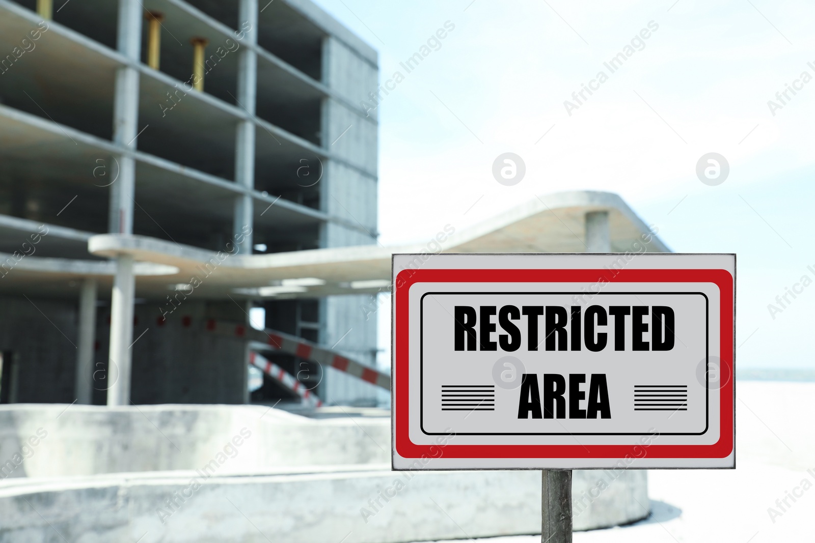Image of Sign with text Restricted Area near unfinished building outdoors
