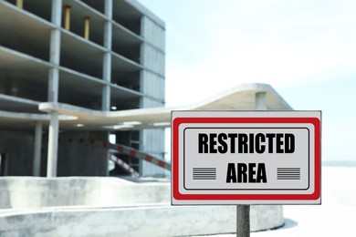 Sign with text Restricted Area near unfinished building outdoors