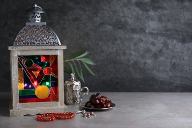 Photo of Composition with Arabic lantern on grey table. Space for text