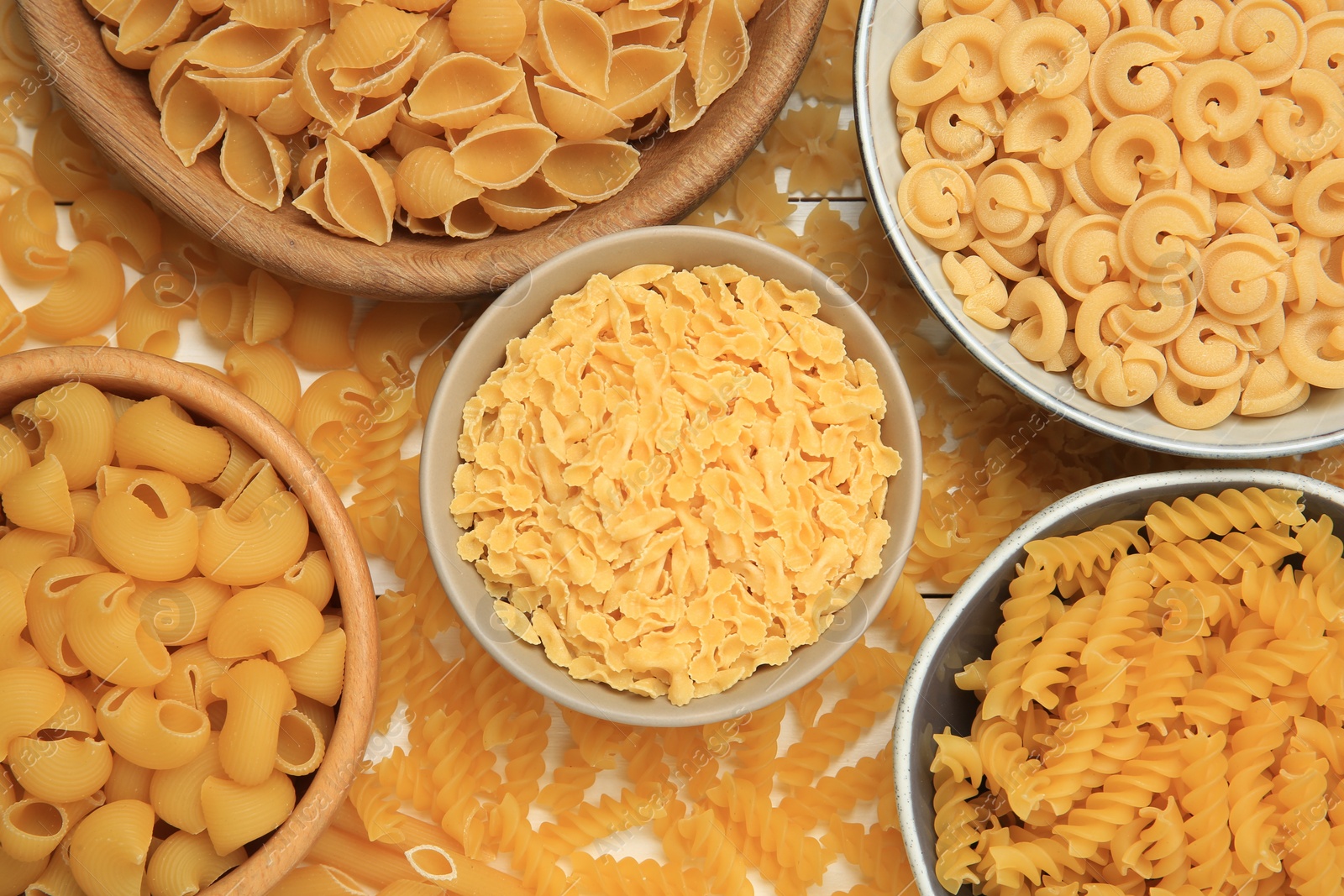 Photo of Different types of pasta on table, flat lay