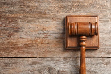 Photo of Judge's gavel on wooden background, top view. Law concept