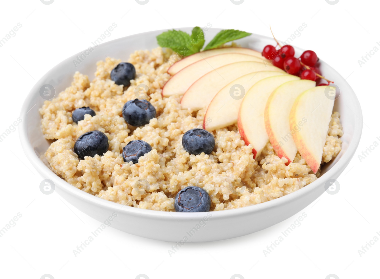 Photo of Bowl of delicious cooked quinoa with apples, blueberries and cranberries isolated on white