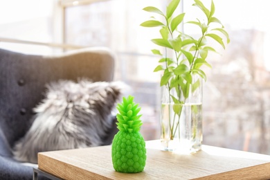 Pineapple shaped candle on table in room