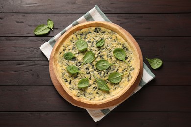 Photo of Delicious homemade spinach pie on wooden table, flat lay