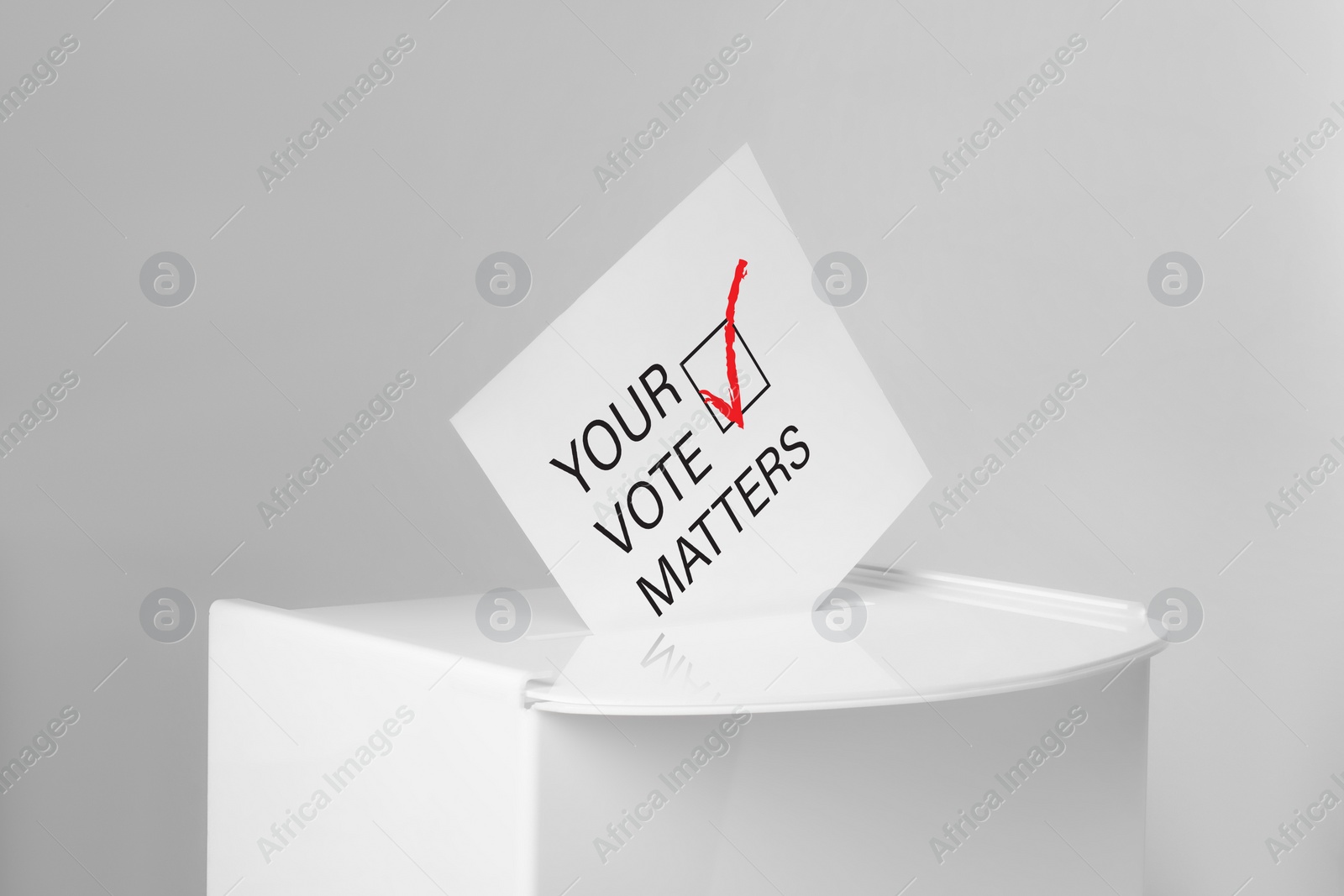 Image of Paper with text Your Vote Matters and tick sticking out of ballot box on light grey background