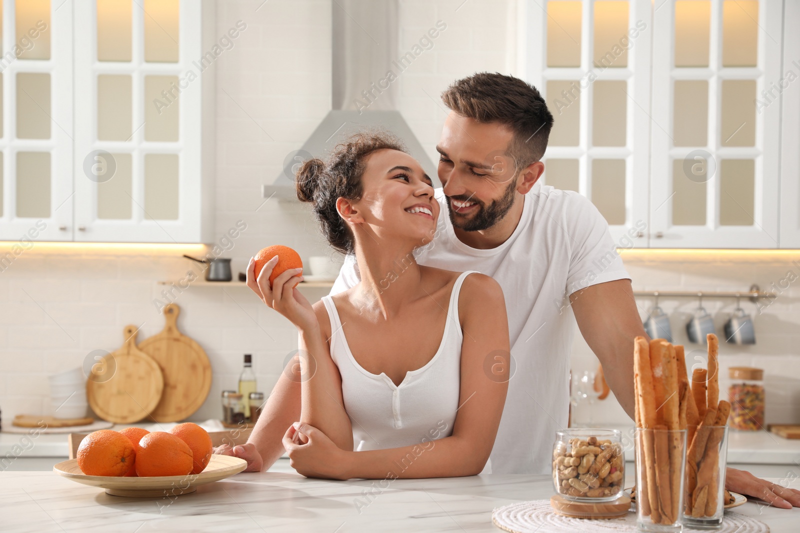 Photo of Lovely couple enjoying time together during breakfast at table in kitchen