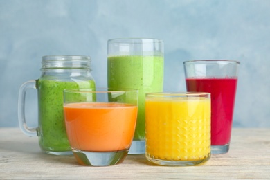 Glassware with delicious detox smoothies on table