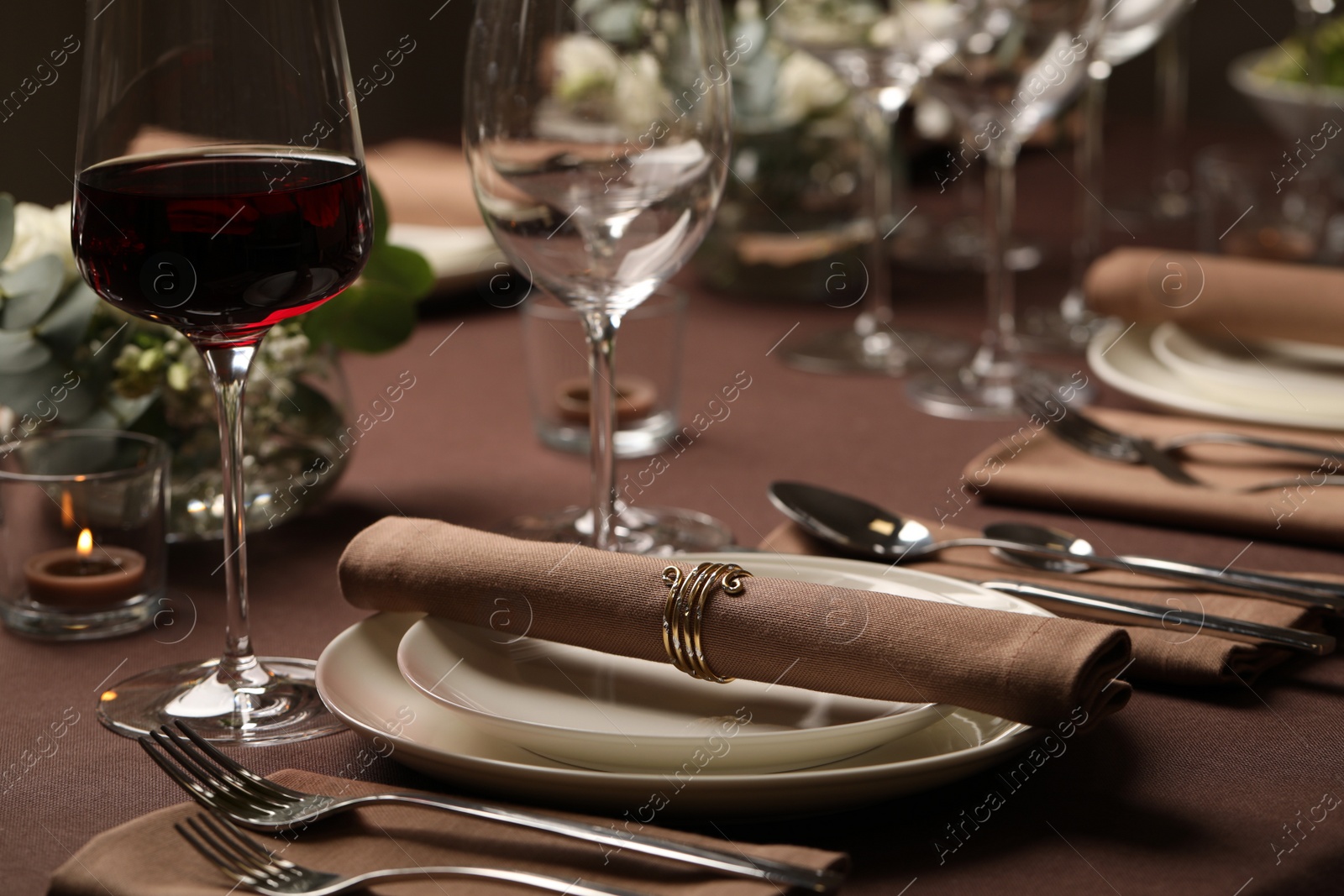 Photo of Glass of delicious wine and elegant table setting in restaurant