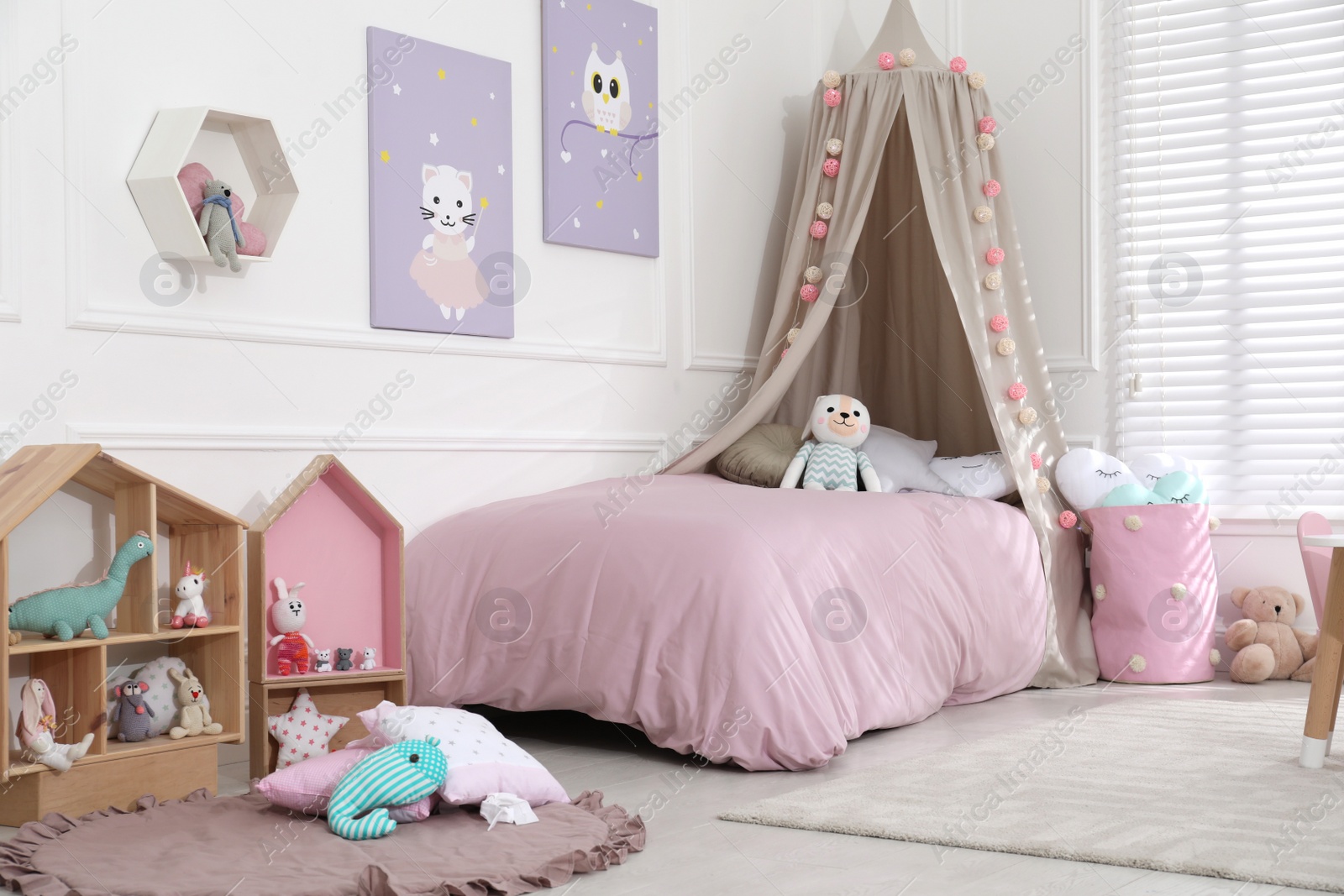 Photo of Cute child's room interior with toys and modern furniture